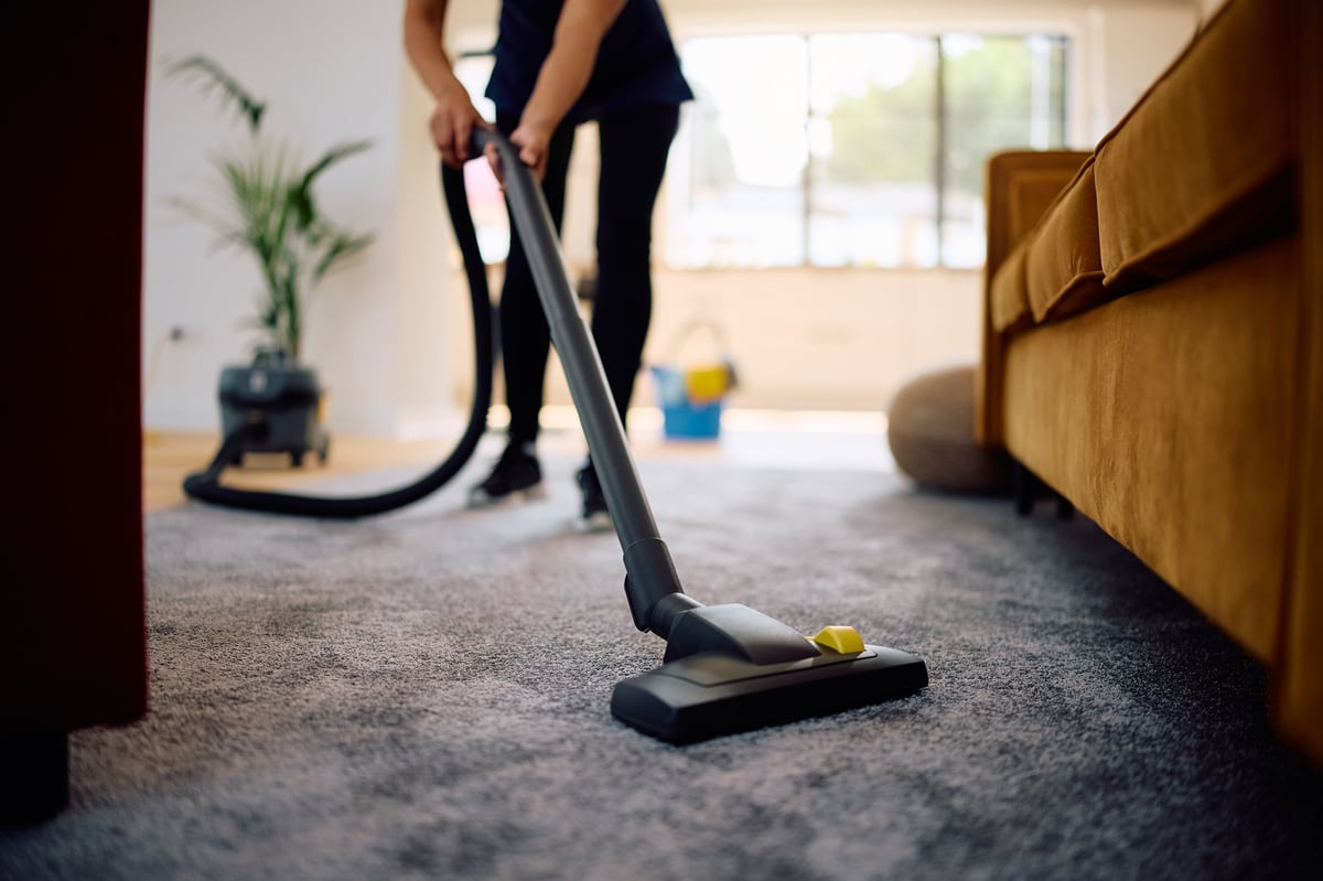 Professional cleaner vacuuming a spotless home interior