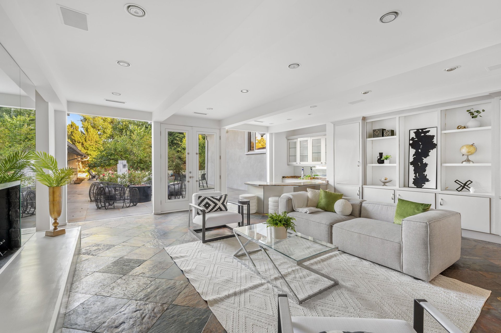 Modern living room with white furniture, fireplace, and open layout
